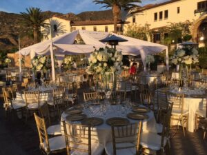 hummingbird nest ranch tent with draping and lighting chiavari chairs white dance floor